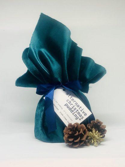 Irish cream liqueur pudding wrapped in teal velvet and tied with midnight blue ribbon