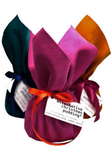 3 puddings wrapped in pink, blue and orange velvet and tied with ribbon